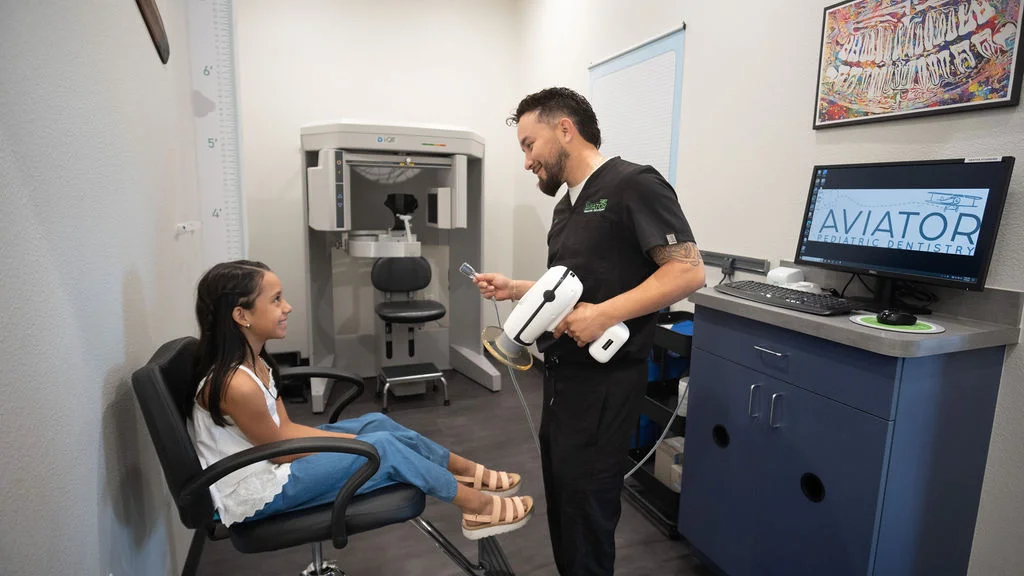 dental-assistant-with-little-happy-girl-fluroide-treatment-aviator-pediatric-children's-dentistry-Watauga-TX